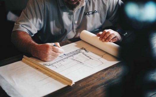 Man sketching architectural plan